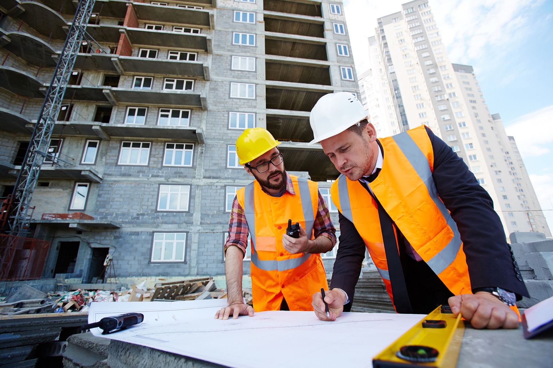 Electrical contractor reviewing plans on site